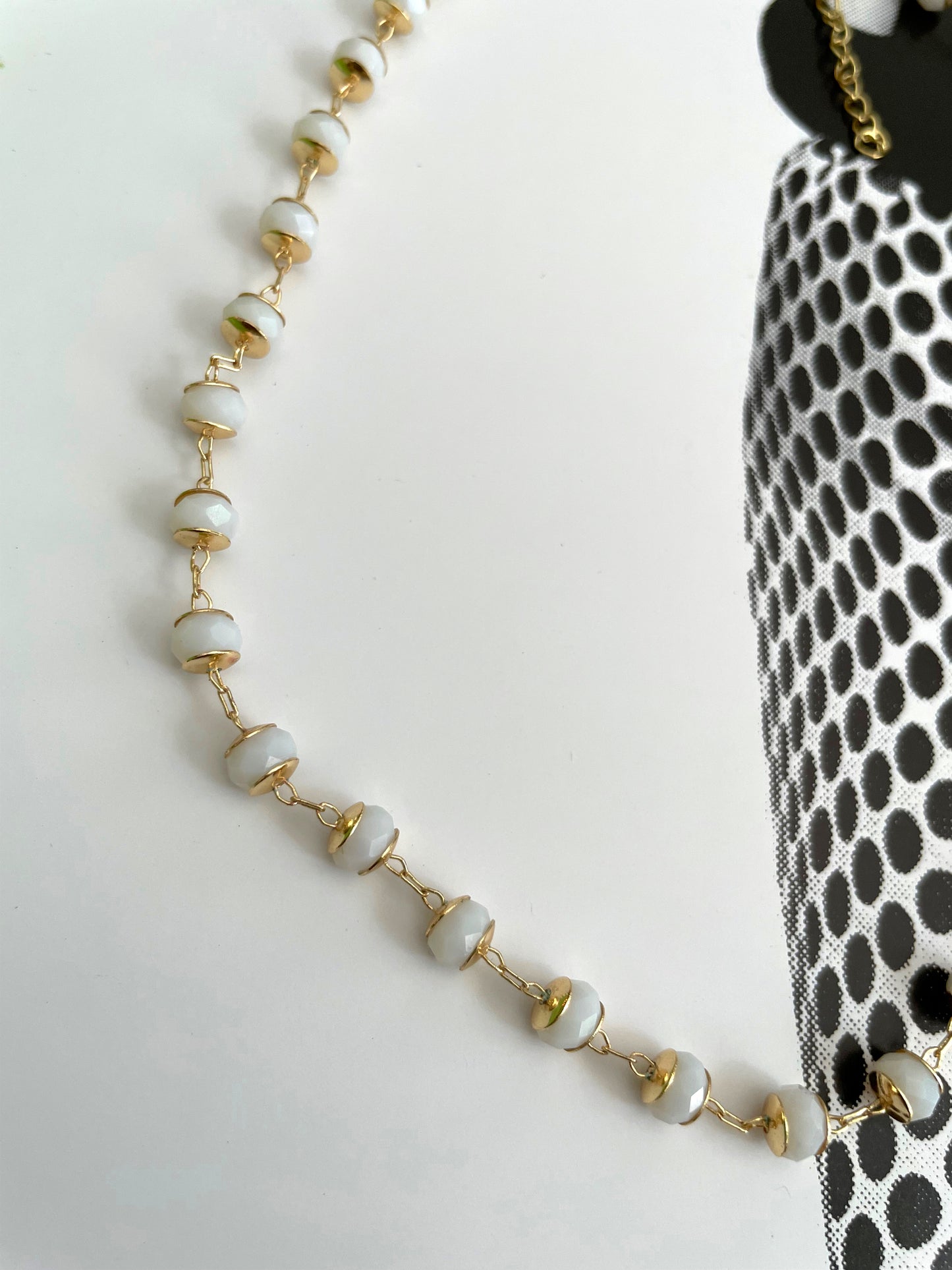 White crystals on gold necklace